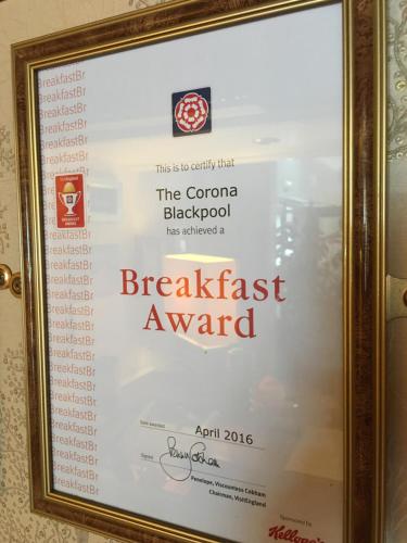 a framed sign for the popcorn blackpool breakfast award at Corona Blackpool in Blackpool