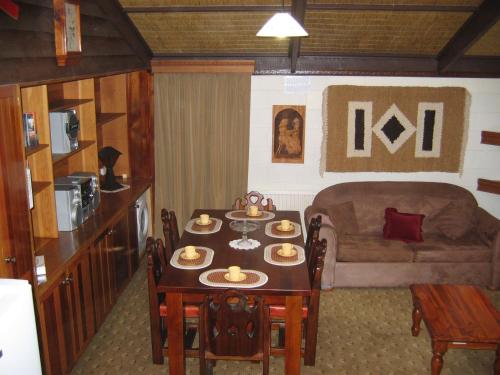 a living room with a table and a couch at Brucktal Apartment in Falls Creek