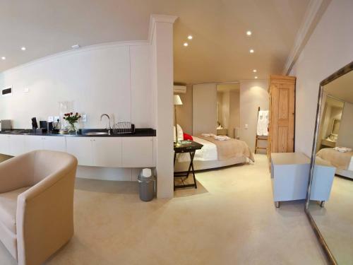 a hotel room with a kitchen and a bedroom at Rouge on Rose Boutique Hotel in Cape Town