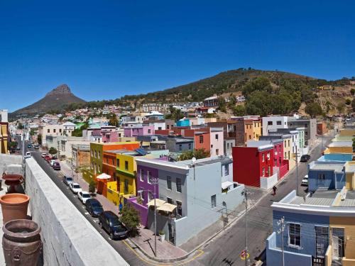 a city with colorful buildings and a mountain at Rouge on Rose Boutique Hotel in Cape Town