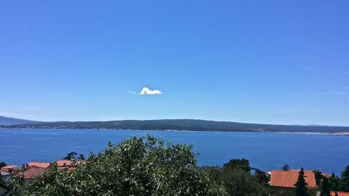 a cloud in the sky over a large body of water at Superior Apartments Ljiljana, Sanja with Sea view in Dramalj in Dramalj
