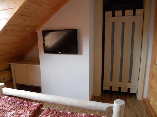 a living room with a flat screen tv on a wall at Penzion U Fábů in Lednice