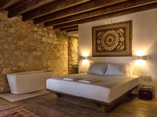 a bedroom with a bed and a bath tub at Trinity Boutique Hotel in Rhodes Town