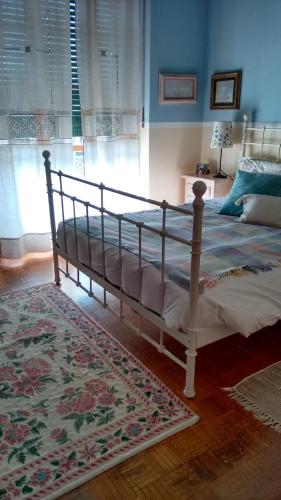 a bedroom with a large bed with a rug at Ca' Mia Ca' Tua in La Loggia