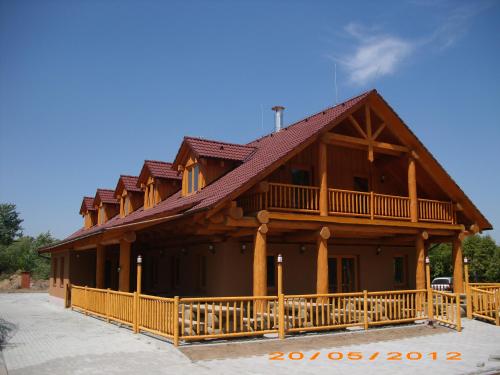 a large wooden house with a gambrel roof at Penzion U Fábů in Lednice