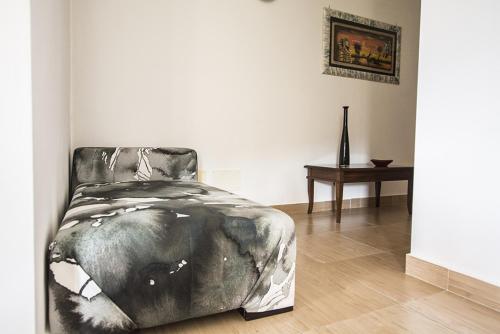 a bed sitting in a room with a table at B&B casa73 in Cicerale