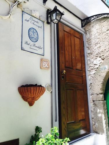 a door to a building with a sign on it at Locanda dell'Arcangelo in Rocca Massima