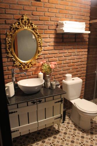 a bathroom with a sink and a toilet and a mirror at Han Boutique Hotel in Sarigerme
