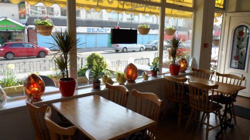 a dining room with a table and chairs and a window at The Danescourt in Blackpool