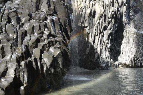 a painting of a rock wall with a rainbow at B&B Villa Grazia in Pagliara