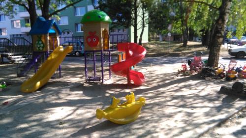 a playground in a park with slides and play equipment at Penzion V Ráji in Strakonice