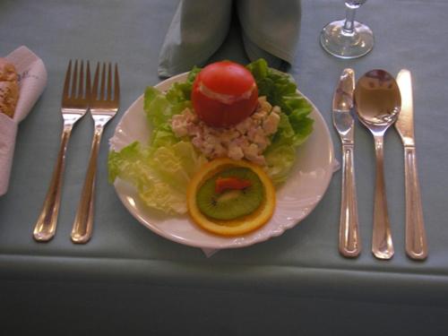 a plate of food on a table with silverware at Penzion V Ráji in Strakonice