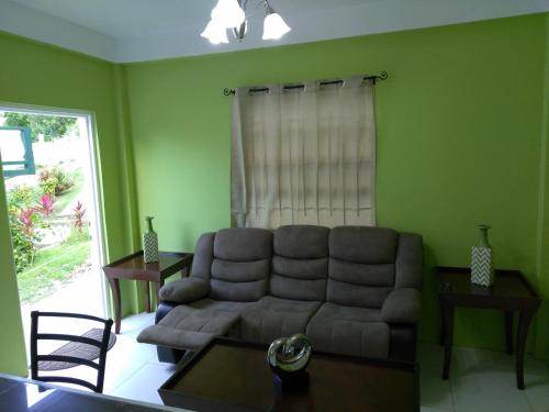 a living room with a couch and a table at Caribbean Dream Vacation Property CD2 in Rodney Bay Village