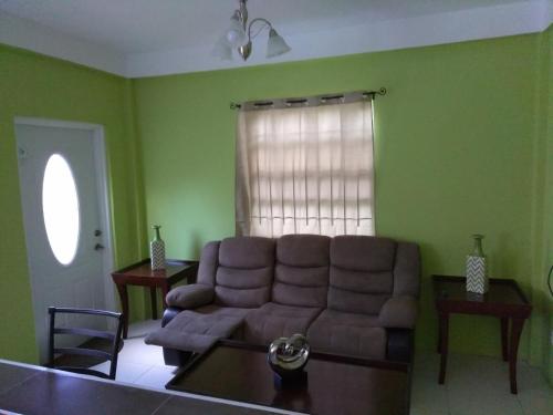 a living room with a couch and a table at Caribbean Dream Vacation Property CD2 in Rodney Bay Village