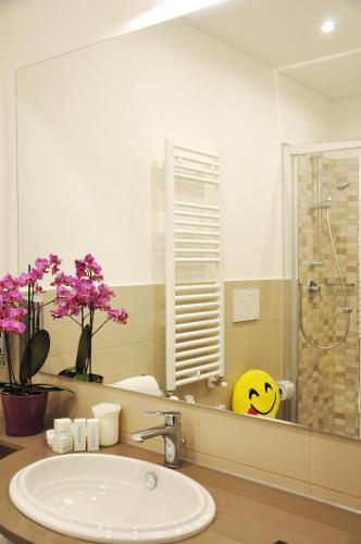 a bathroom with a sink and a mirror at Hotel Adelphi in Riccione