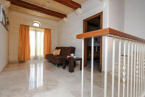 a living room with a couch and a table at Carini Farmhouses in Għarb