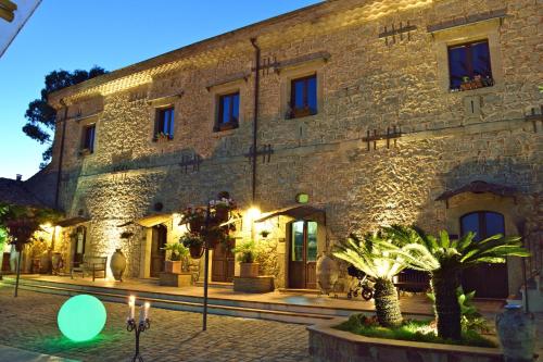 an old stone building with lights in front of it at Agriturismo Vecchia Masseria Charme&Relax in San Michele di Ganzaria