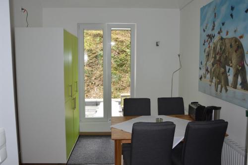 a dining room with a table and chairs at Ferienapartments Cafe Stilbruch in Heimbach