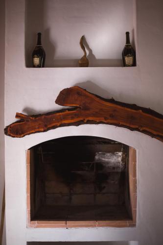 a fireplace with two bottles on top of it at Carü Leufu in Valle Grande