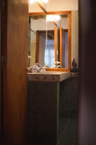 a bathroom with a sink and a mirror at Carü Leufu in Valle Grande