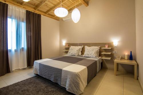 a bedroom with a large bed with two pillows at Friends Bungalows in Kŭrdzhali