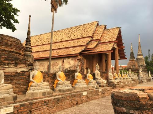 a row of statues in front of a building at Baan Khun ya Ayutthaya in Phra Nakhon Si Ayutthaya