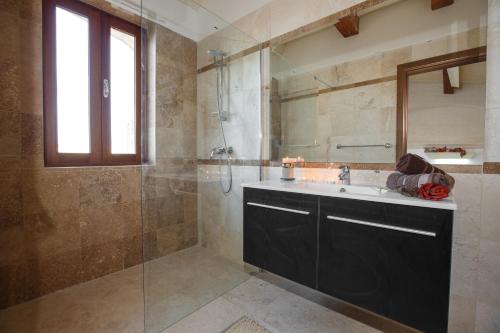 a bathroom with a sink and a shower at Carini Farmhouses in Għarb