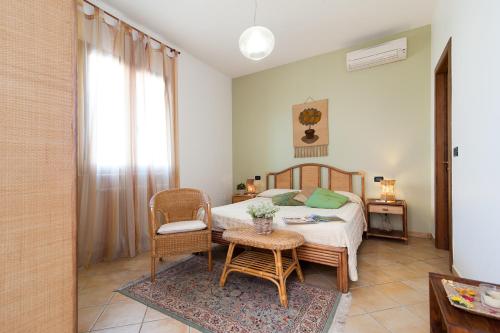 a bedroom with a bed and a table and chairs at Antico Camino B&B in Muro Leccese