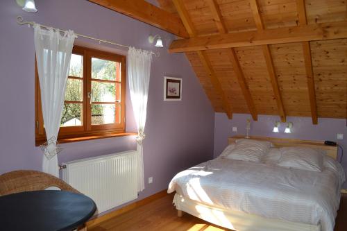 een slaapkamer met een bed en een houten plafond bij Enço deth terralh in Pierrefitte-Nestalas