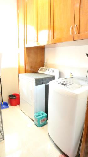 a kitchen with a refrigerator and a washer and dryer at Condo Bellmare in Puerto Aventuras