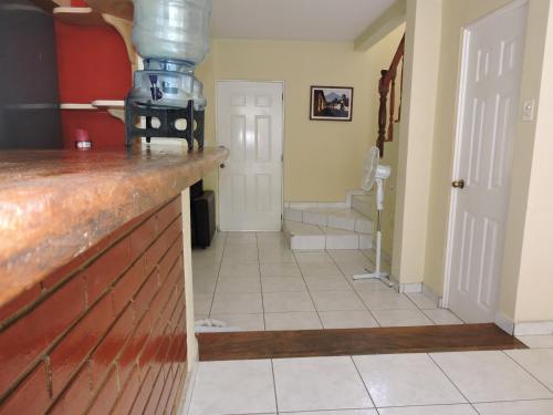 a kitchen with a counter top and a hallway at Cumbres de San Francisco in San Salvador