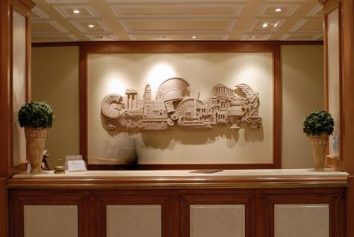 a framed picture of buildings on a wall at Athens Atrium Hotel & Jacuzzi Suites in Athens