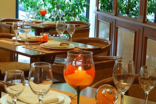 a table with wine glasses on top of it at Athens Atrium Hotel & Jacuzzi Suites in Athens