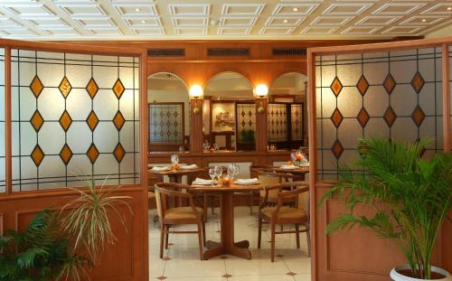 a dining room with a table and chairs at Athens Atrium Hotel & Jacuzzi Suites in Athens