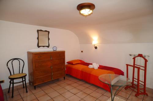 a bedroom with a bed and a dresser and a glass table at Daniela House in Maiori