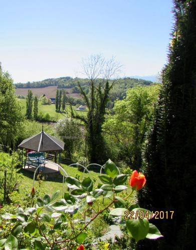 a view of a garden with a gazebo and flowers at Les Gîtes de La Maison Bleue d'Estialescq in Estialescq