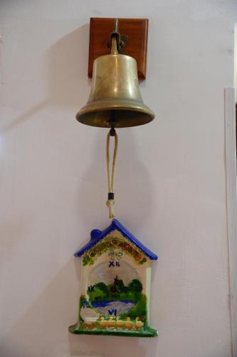 a bell hanging from a wall at Daniela House in Maiori