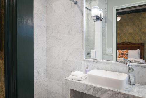 a bathroom with a white sink and a mirror at Monte Cristo Bed and Breakfast in San Francisco