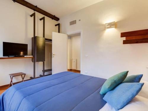 a bedroom with a large blue bed with blue pillows at Folia Domus - Vatican City in Rome