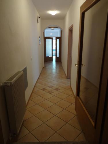 a hallway with a door and a tiled floor at Fedrig Private Rooms & Apartment in Kobarid