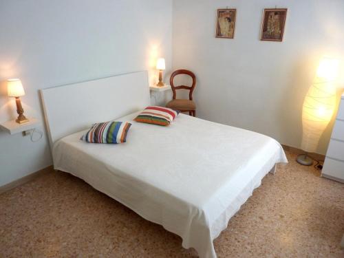 una camera da letto con un letto bianco con due cuscini sopra di Tommy Guest House Roma a Roma