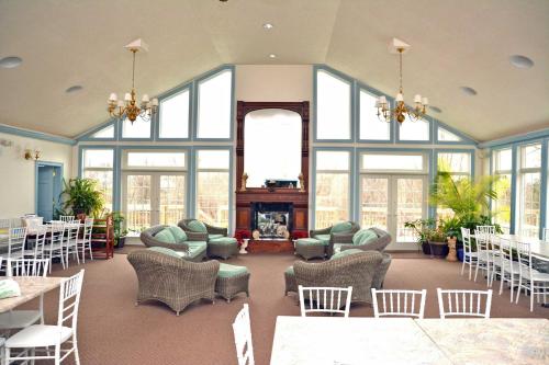 a large room with windows and chairs and a fireplace at Battlefield Bed & Breakfast in Gettysburg