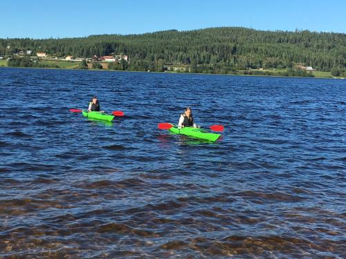 two people in kayaks in a large body of water at Ljusdals Camping in Ljusdal