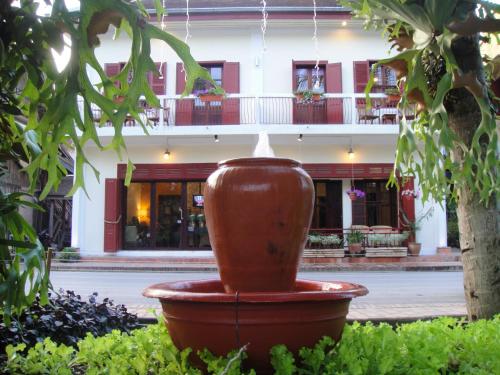 a large pot sitting in front of a building at Luang Prabang Nagara Villa River View in Luang Prabang