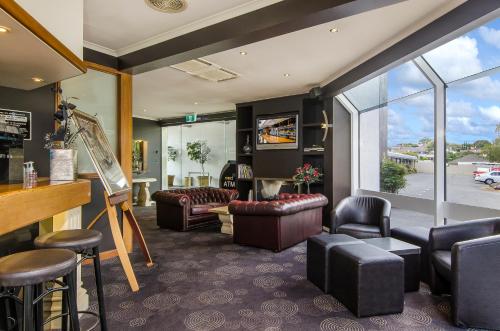 a living room filled with furniture and a large window at The Commodore in Mount Gambier