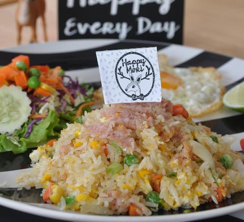 a plate of food with rice and vegetables with a happy new year sign at M2 Hotel in Phayao