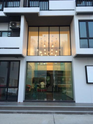 a building with glass windows and a chandelier at M2 Hotel in Phayao