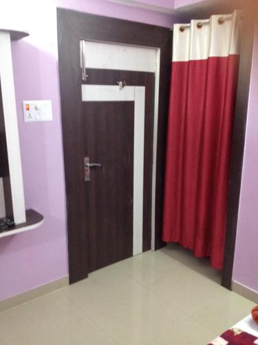 a room with a door and a red curtain at Hotel Viraat Inn in Gaya
