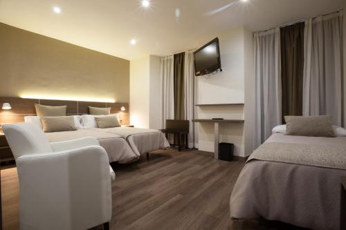 Postel nebo postele na pokoji v ubytování Hotel Don Paco