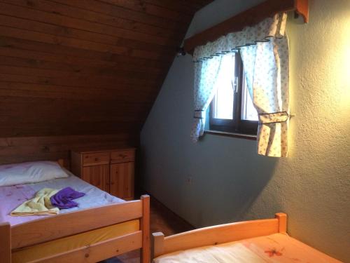 a bedroom with a bed and a window at Apartma Gracner in Bled